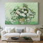 Canvas art print detailing a stylized botanical scene with soft tones, centered above a sofa as a large focal wall piece
