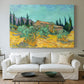 Canvas art print detailing a stylized rural setting with trees and structures, centered above a sofa as a large focal wall piece