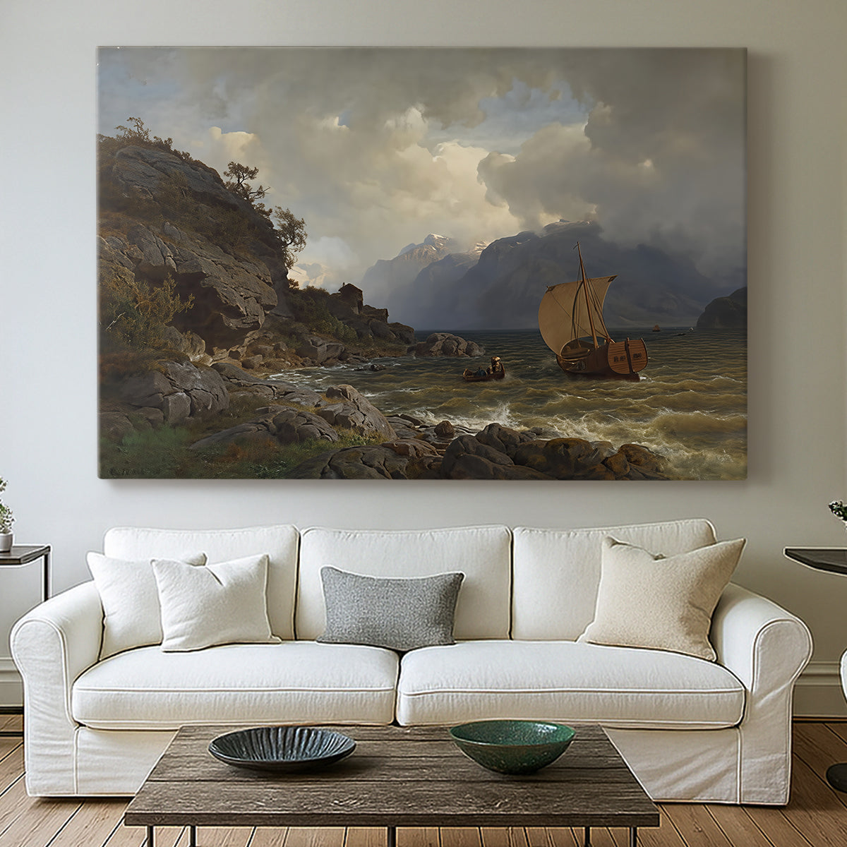 Canvas art print detailing a Nordic coastal scene with waves and distant vessels, centered above a sofa as a large focal wall piece