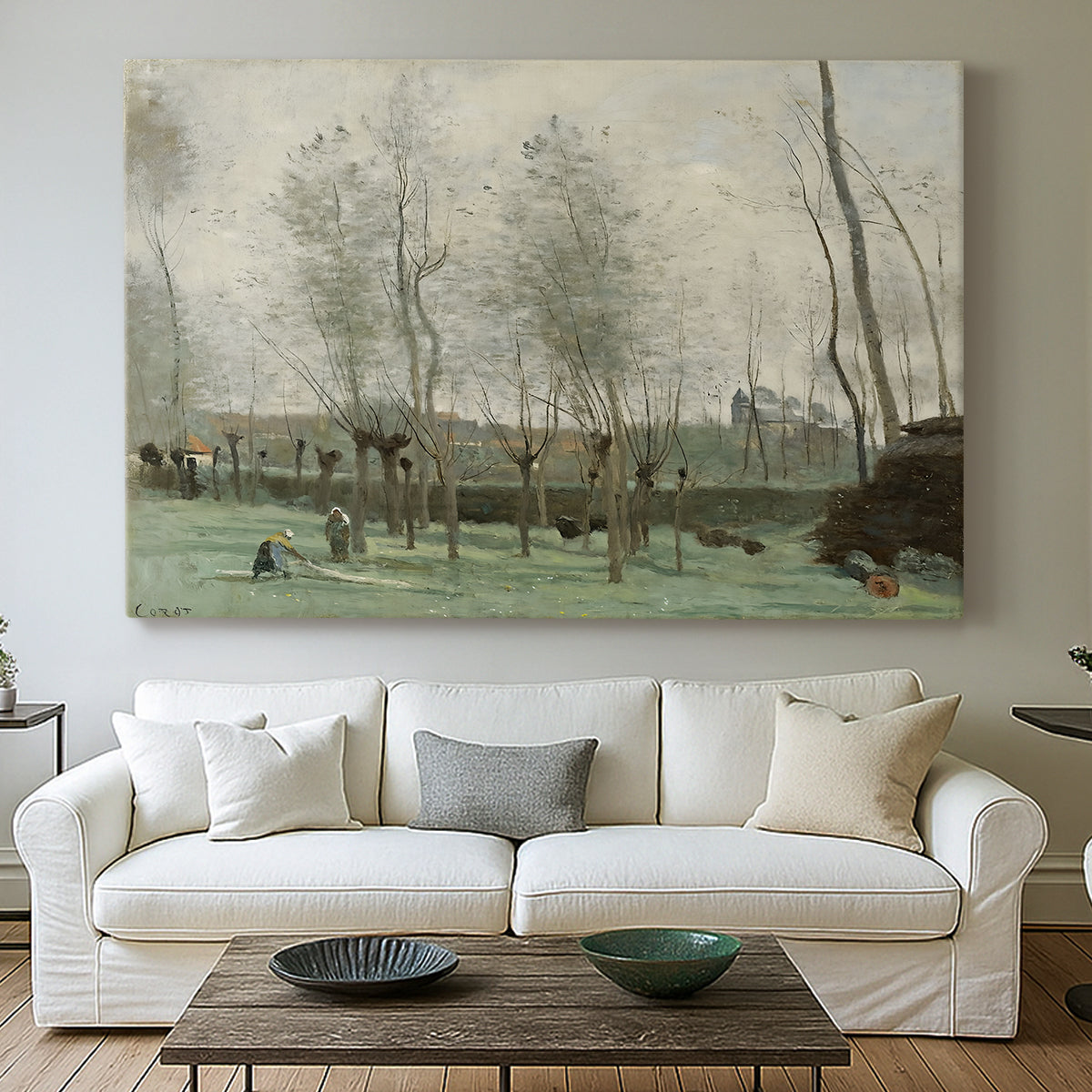 Canvas art print detailing a tranquil outdoor scene with washerwomen and foliage, centered above a sofa as a large focal wall piece
