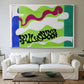 Canvas art print detailing a stylized cut-out design evoking water, centered above a sofa as a large focal wall piece