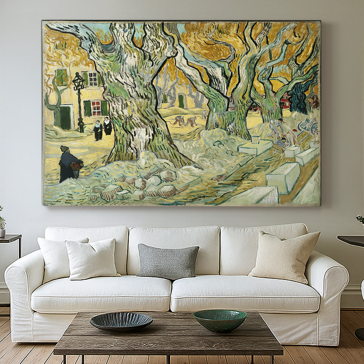 Canvas art print detailing a landscape featuring tall trunks and figures in shaded area, centered above a sofa as a large focal wall piece