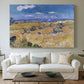 Canvas art print detailing a post-impressionist composition with field and worker, centered above a sofa as a large focal wall piece
