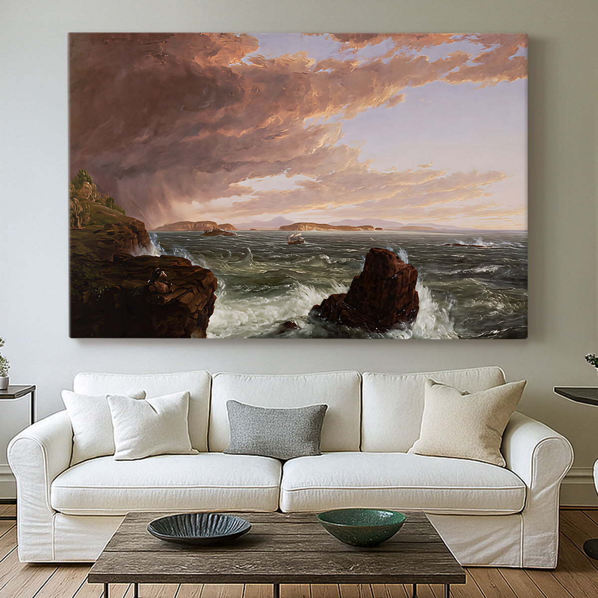Canvas art print detailing an expansive seascape with light breaking through clouds, centered above a sofa as a large focal wall piece