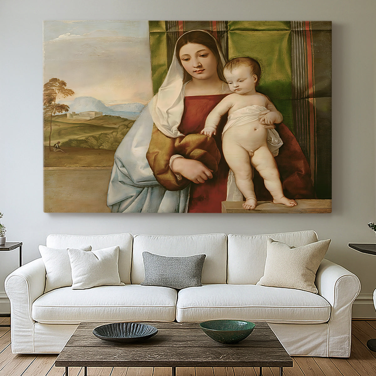 Canvas art print detailing a devotional image with seated woman and infant in quiet outdoor scene, centered above a sofa as a large focal wall piece