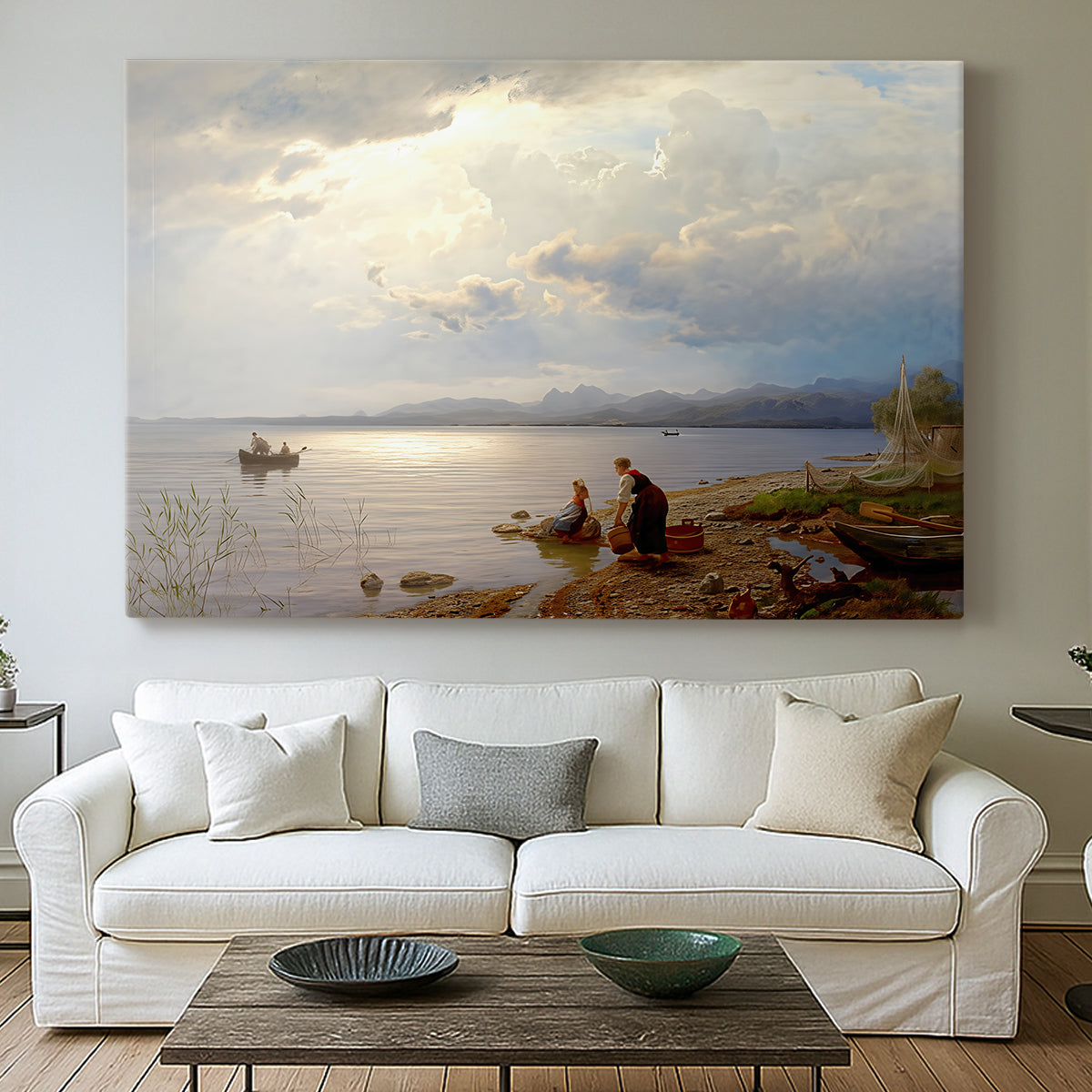 Canvas art print detailing a calm landscape with shoreline activity and soft sky, centered above a sofa as a large focal wall piece