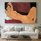 Canvas art print detailing an expressionist painting of nude woman reclining with minimal background, centered above a sofa as a large focal wall piece