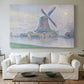Canvas art print detailing a landscape combining structure and water, centered above a sofa as a large focal wall piece
