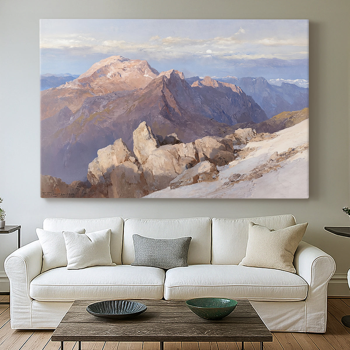 Canvas art print detailing an expansive mountainous landscape with natural depth, centered above a sofa as a large focal wall piece