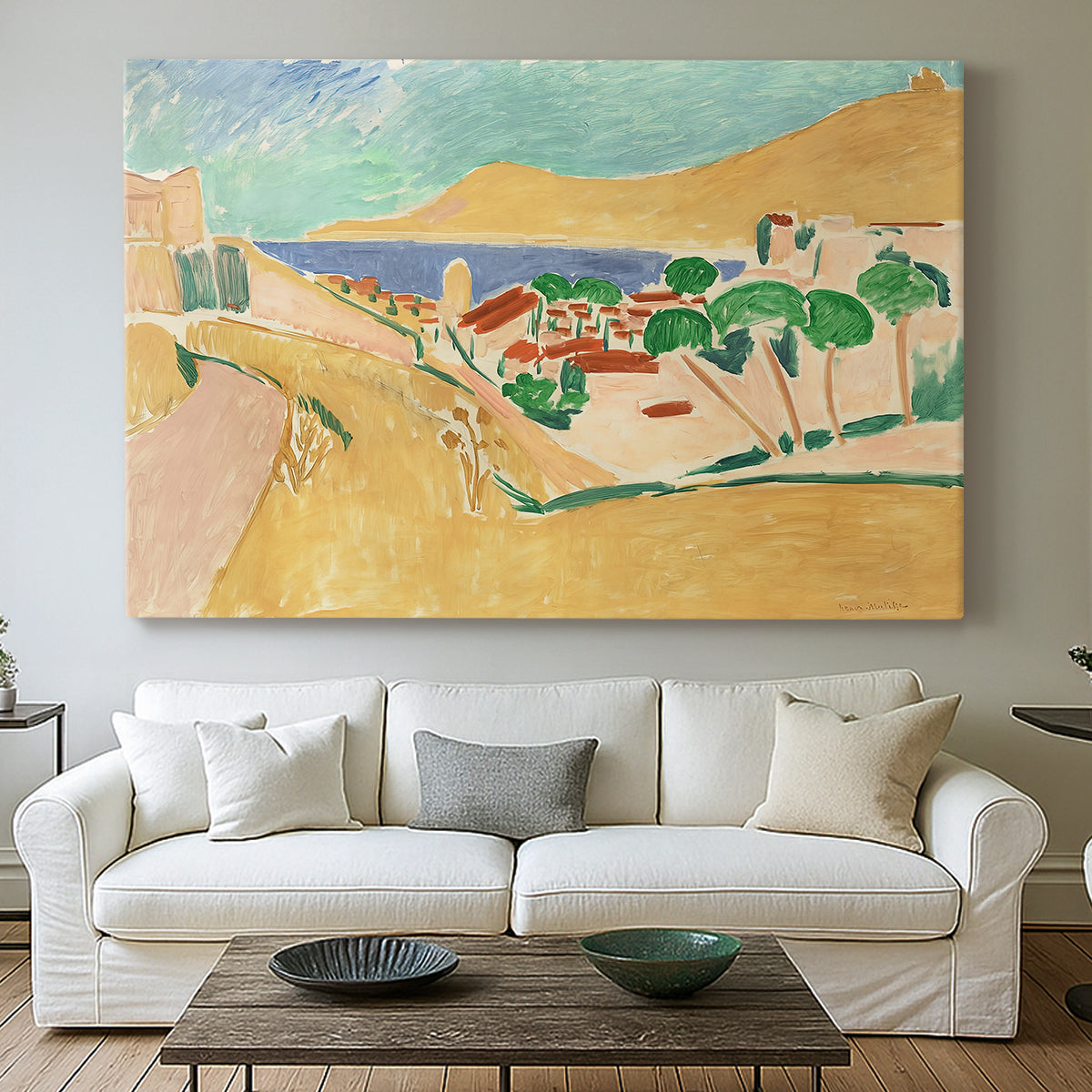 Canvas art print detailing a colorful village scene with water and architecture, centered above a sofa as a large focal wall piece