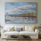Canvas art print detailing a tranquil composition with riverbank, centered above a sofa as a large focal wall piece