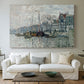 Canvas art print detailing a harbor view with masts, houses, and reflections in water, centered above a sofa as a large focal wall piece