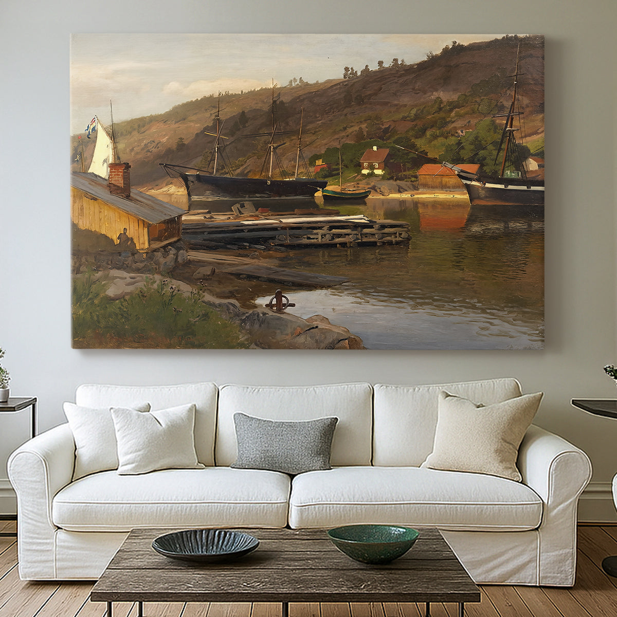 Canvas art print detailing a tranquil harbor landscape with nautical activity, centered above a sofa as a large focal wall piece