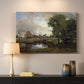 Canvas art print detailing a countryside view with mill and canal, mounted in a softly lit interior space
