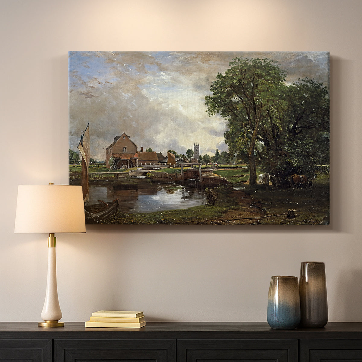 Canvas art print detailing a countryside view with mill and canal, mounted in a softly lit interior space