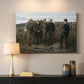 Canvas art print detailing an outdoor group scene centered on military interaction, mounted in a softly lit interior space