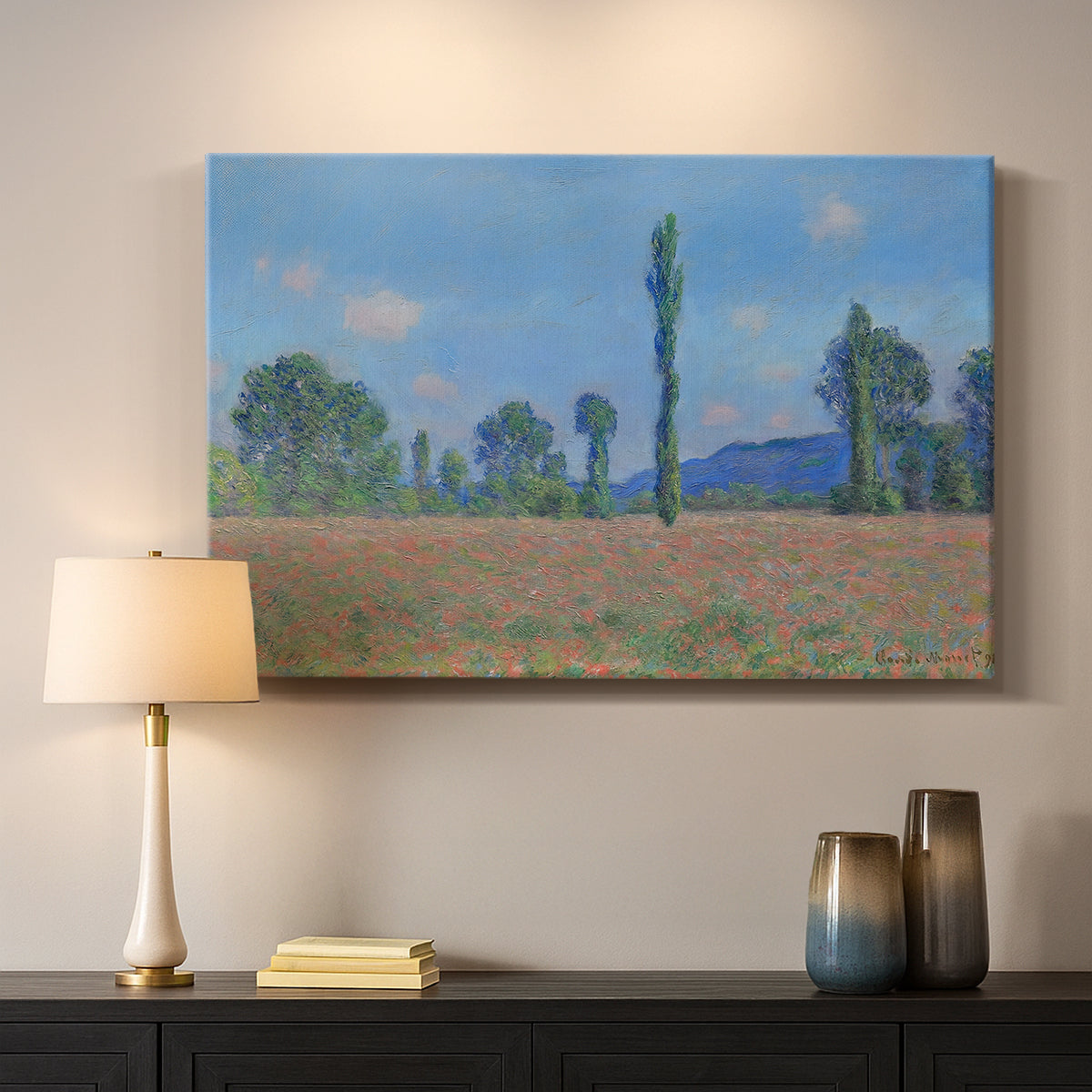 Canvas art print detailing a rural field filled with red blossoms beneath open sky, mounted in a softly lit interior space