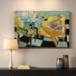 Canvas art print detailing a colorful seated portrait with a flower accent, mounted in a softly lit interior space