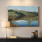 Canvas art print detailing an atmospheric landscape emphasizing turbulent sky over calm terrain, mounted in a softly lit interior space