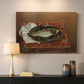Canvas art print detailing a restrained still life of a fish in natural tones, mounted in a softly lit interior space