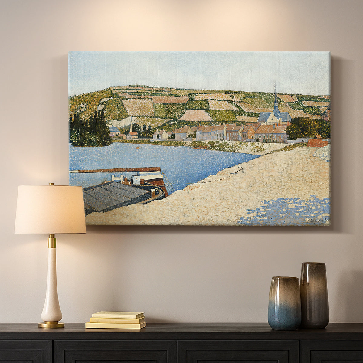 Canvas art print detailing a tranquil river composition with village, mounted in a softly lit interior space