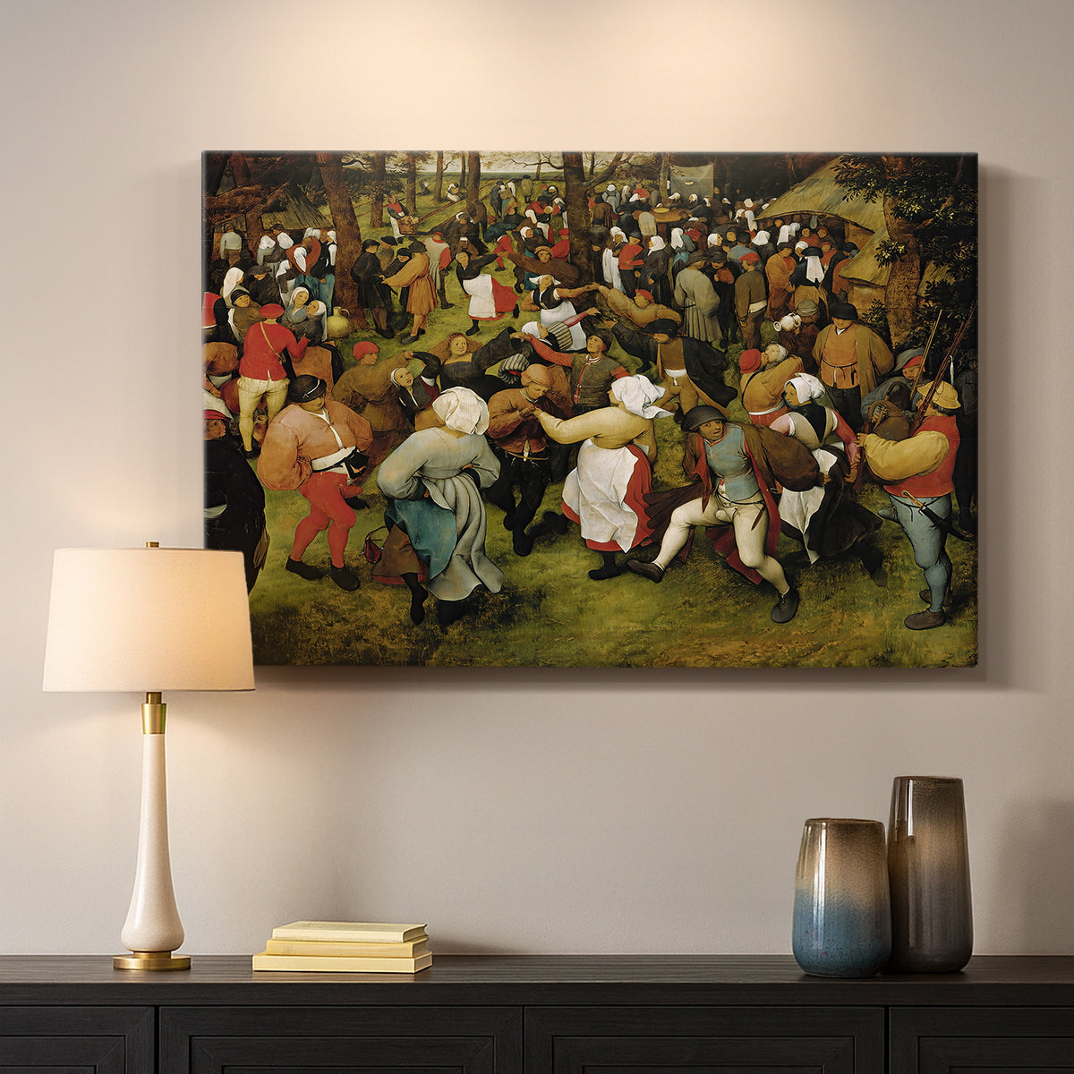 Canvas art print detailing a traditional village wedding scene, mounted in a softly lit interior space