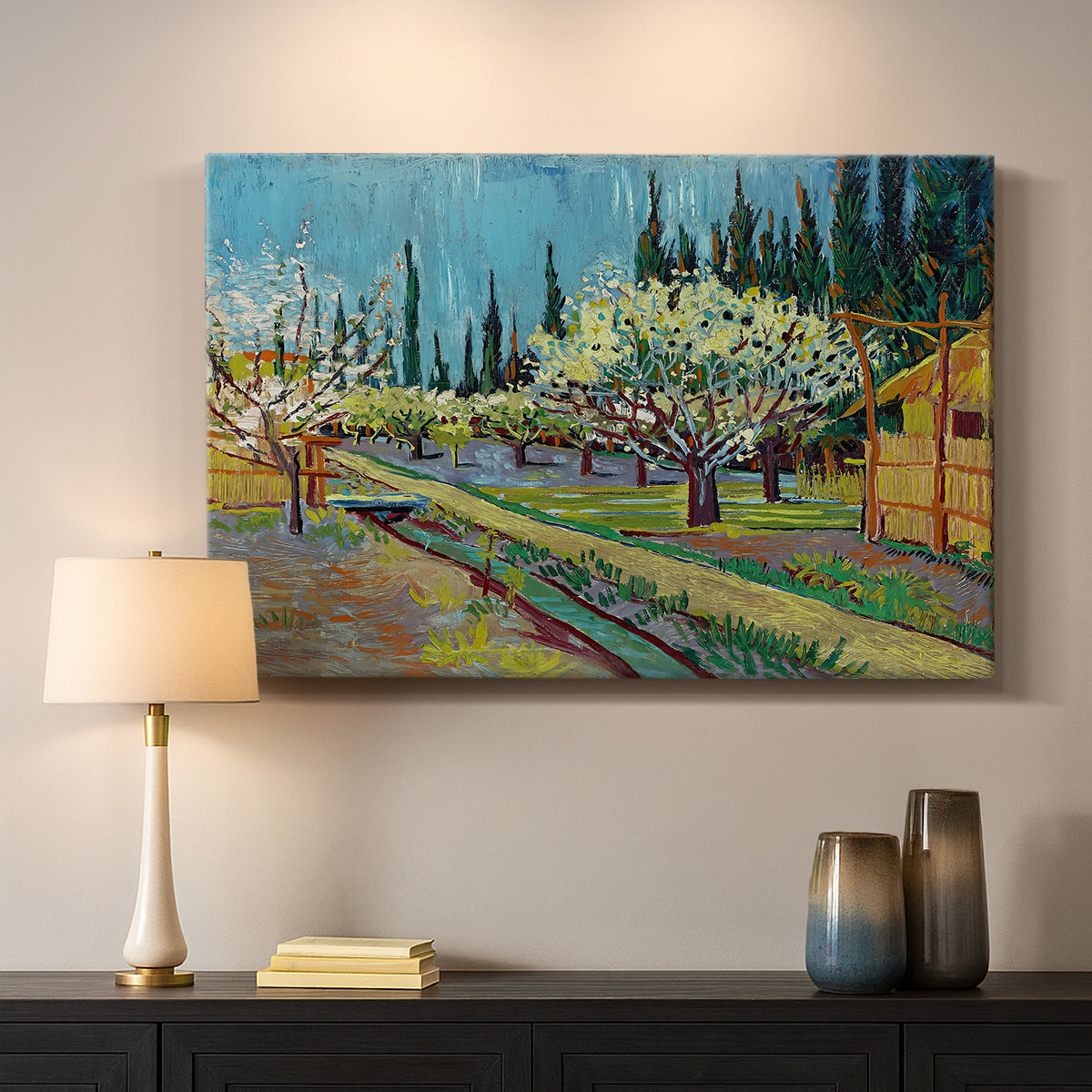 Canvas art print detailing a countryside composition combining flowering trees and structure, mounted in a softly lit interior space