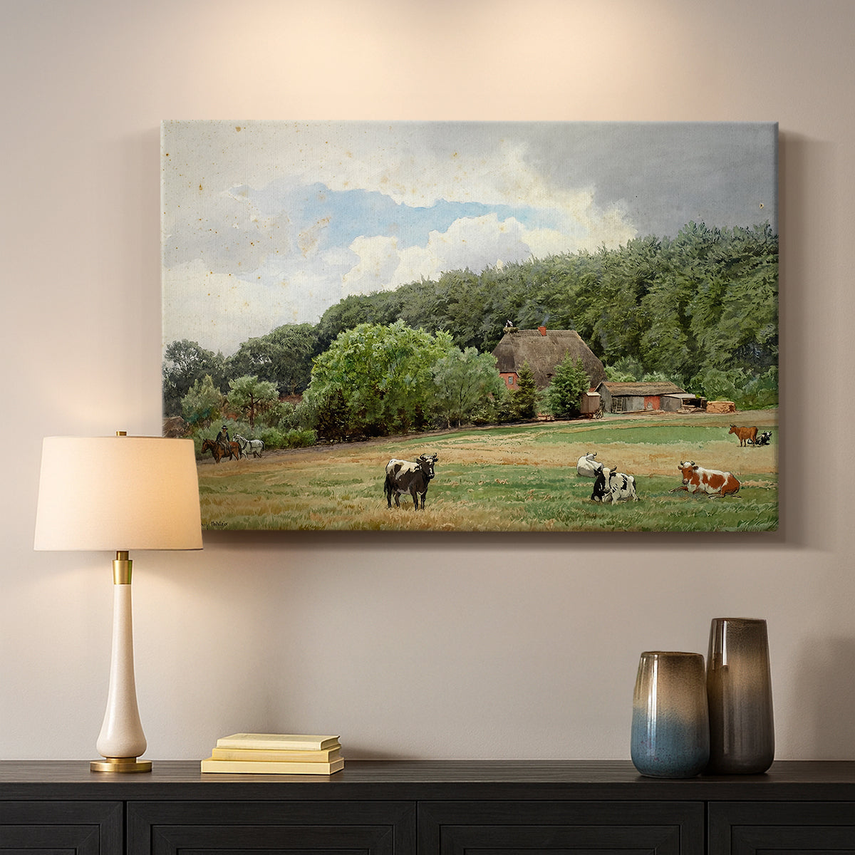 Canvas art print detailing a countryside setting with animals and farmhouse under soft sky, mounted in a softly lit interior space