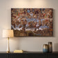 Canvas art print detailing a fresco scene showing turmoil, mounted in a softly lit interior space