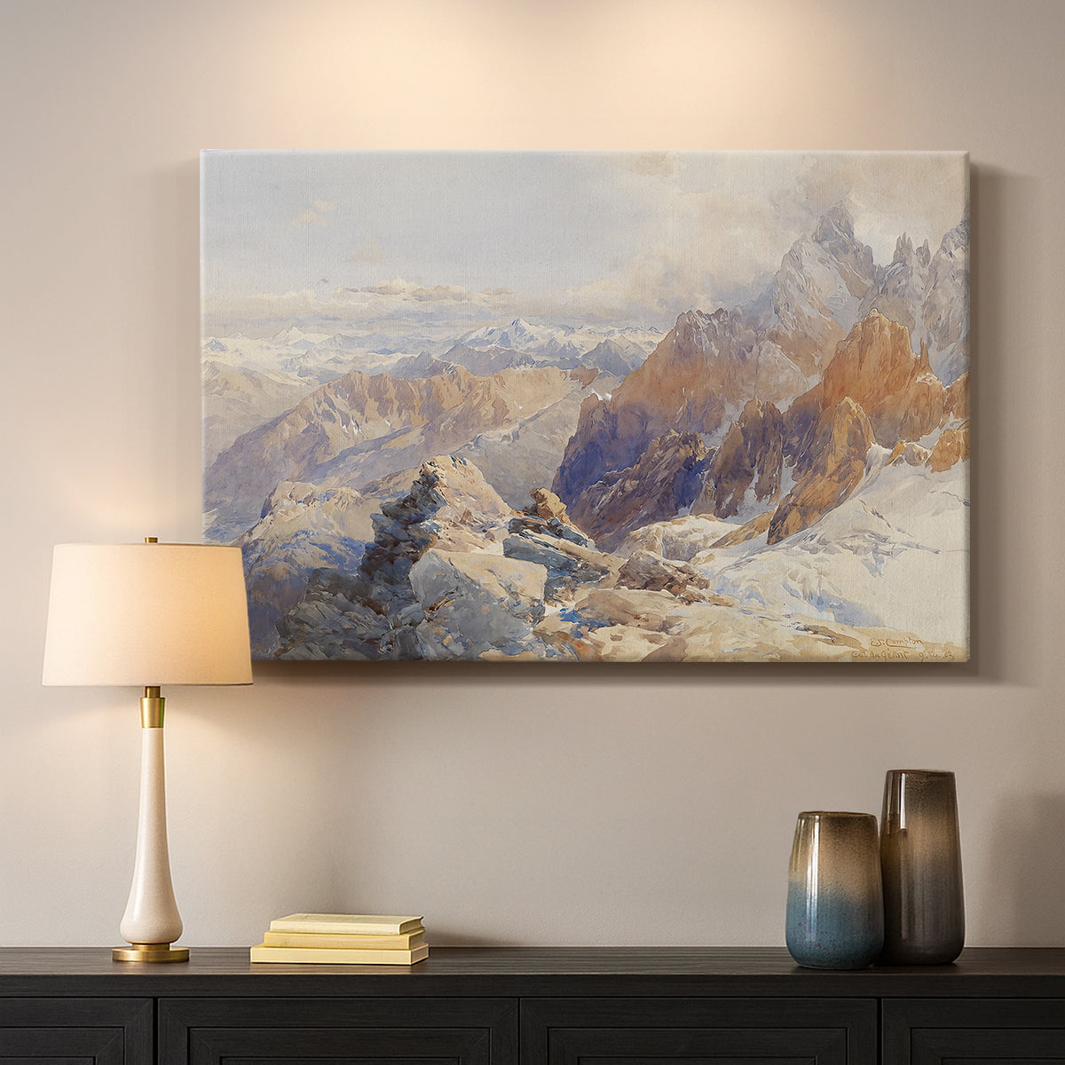 Canvas art print detailing a rugged mountain pass scene with distant peaks, mounted in a softly lit interior space