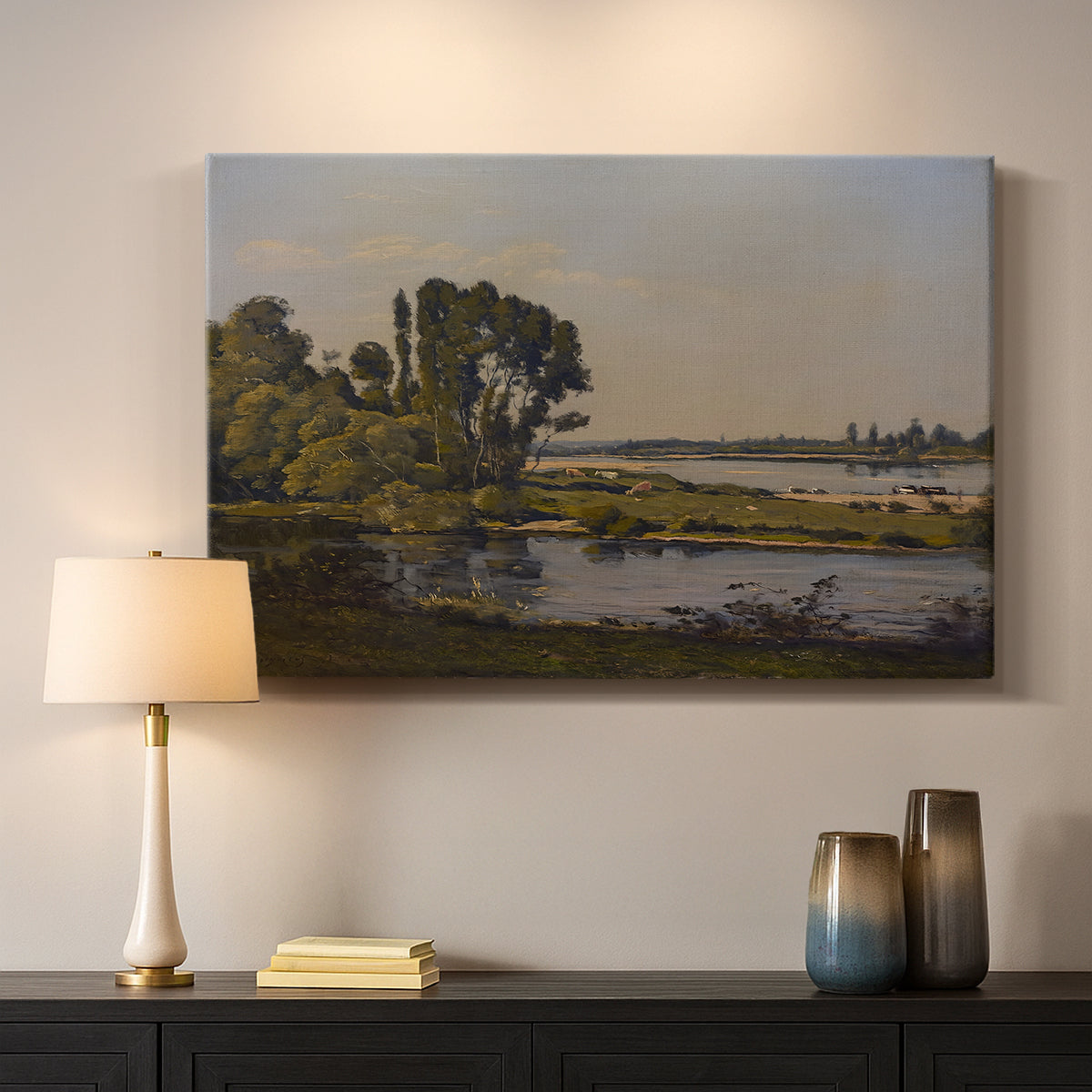 Canvas art print detailing a countryside scene with flowing water and greenery, mounted in a softly lit interior space