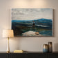 Canvas art print detailing a quiet lake scene with lone person and open horizon, mounted in a softly lit interior space