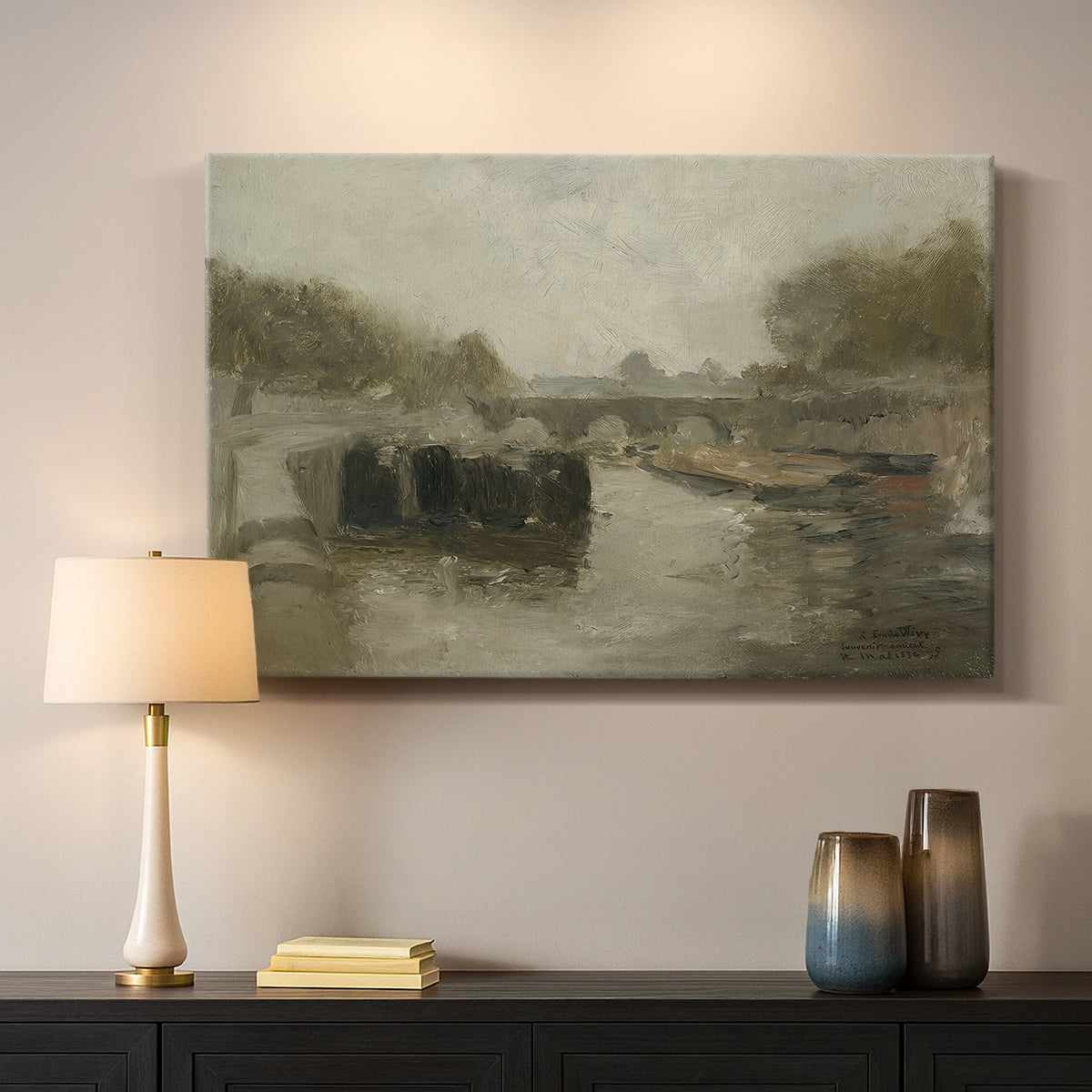 Canvas art print detailing an atmospheric landscape featuring a bridge over water, mounted in a softly lit interior space