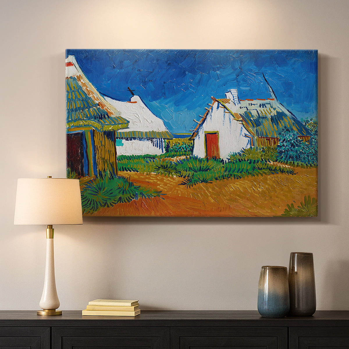Canvas art print detailing a stylized cityscape with cottages and sky, mounted in a softly lit interior space
