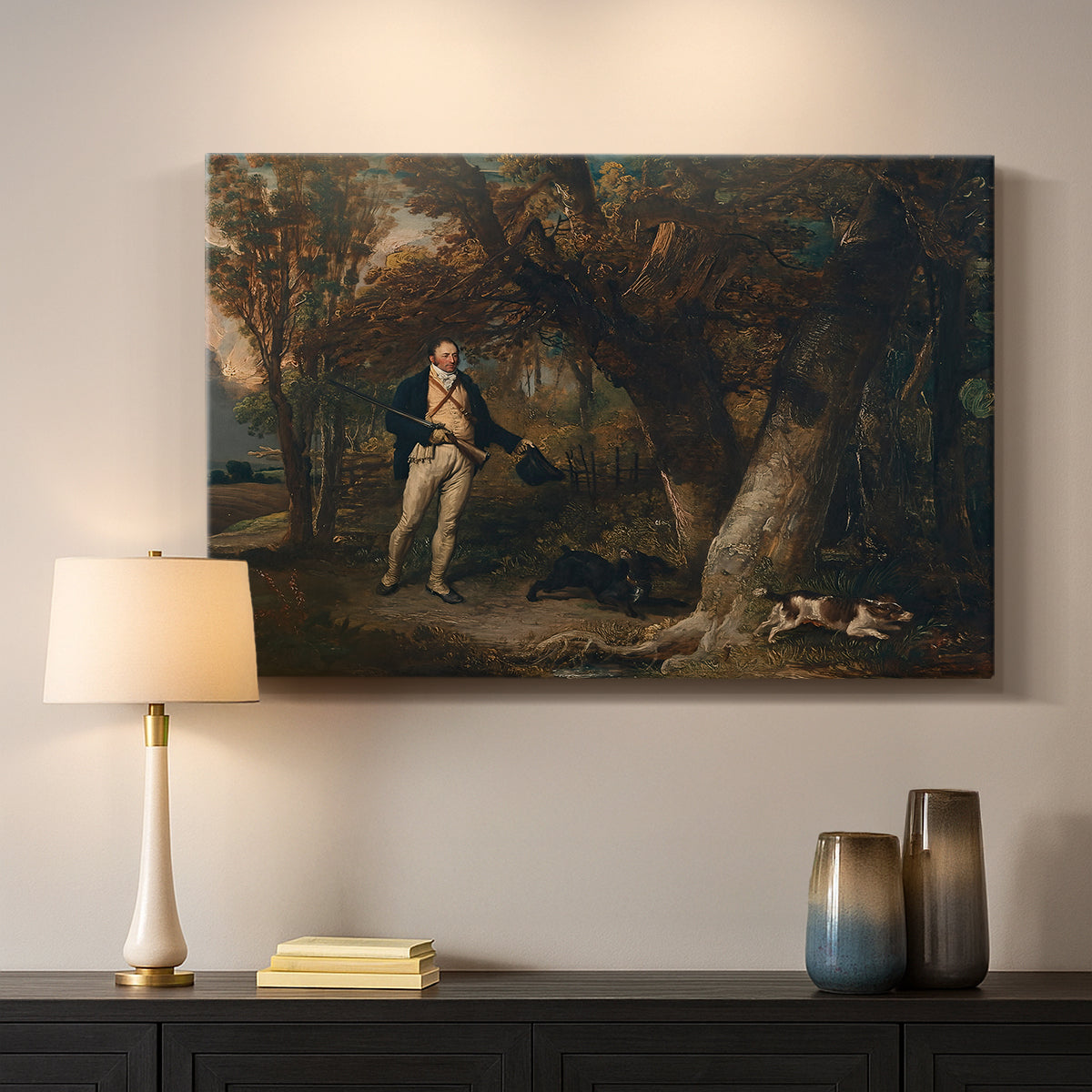 Canvas art print detailing a detailed outdoor scene of man with dogs, mounted in a softly lit interior space