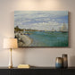 Canvas art print detailing a nautical scene with boats racing near seaside town, mounted in a softly lit interior space