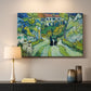 Canvas art print detailing a stylized cityscape with stairway and houses, mounted in a softly lit interior space