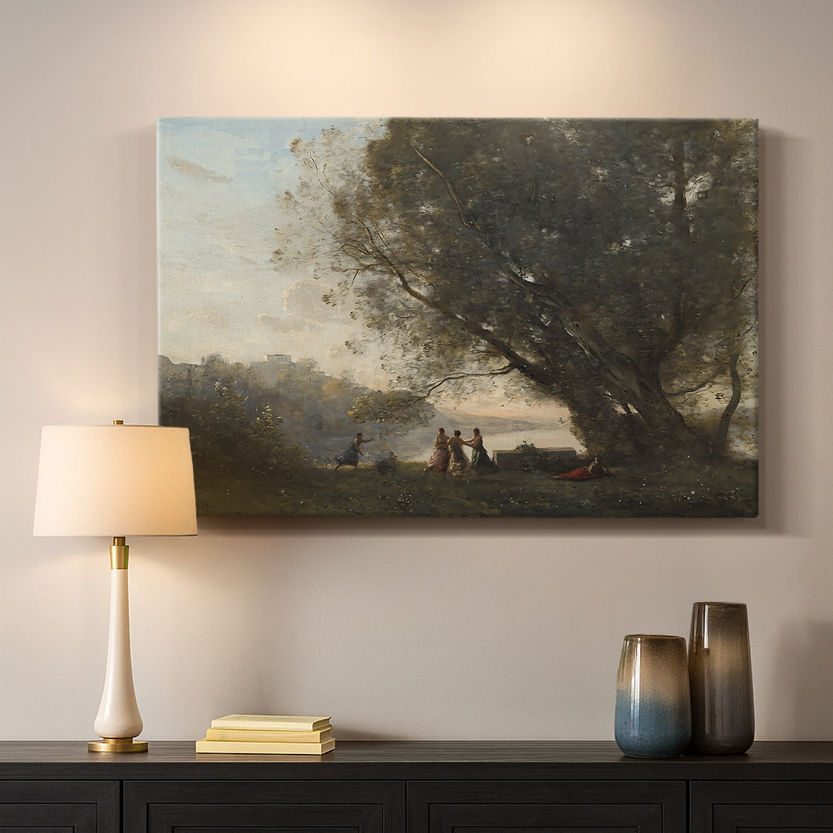 Canvas art print detailing a tranquil outdoor composition with dancing figures and lake, mounted in a softly lit interior space