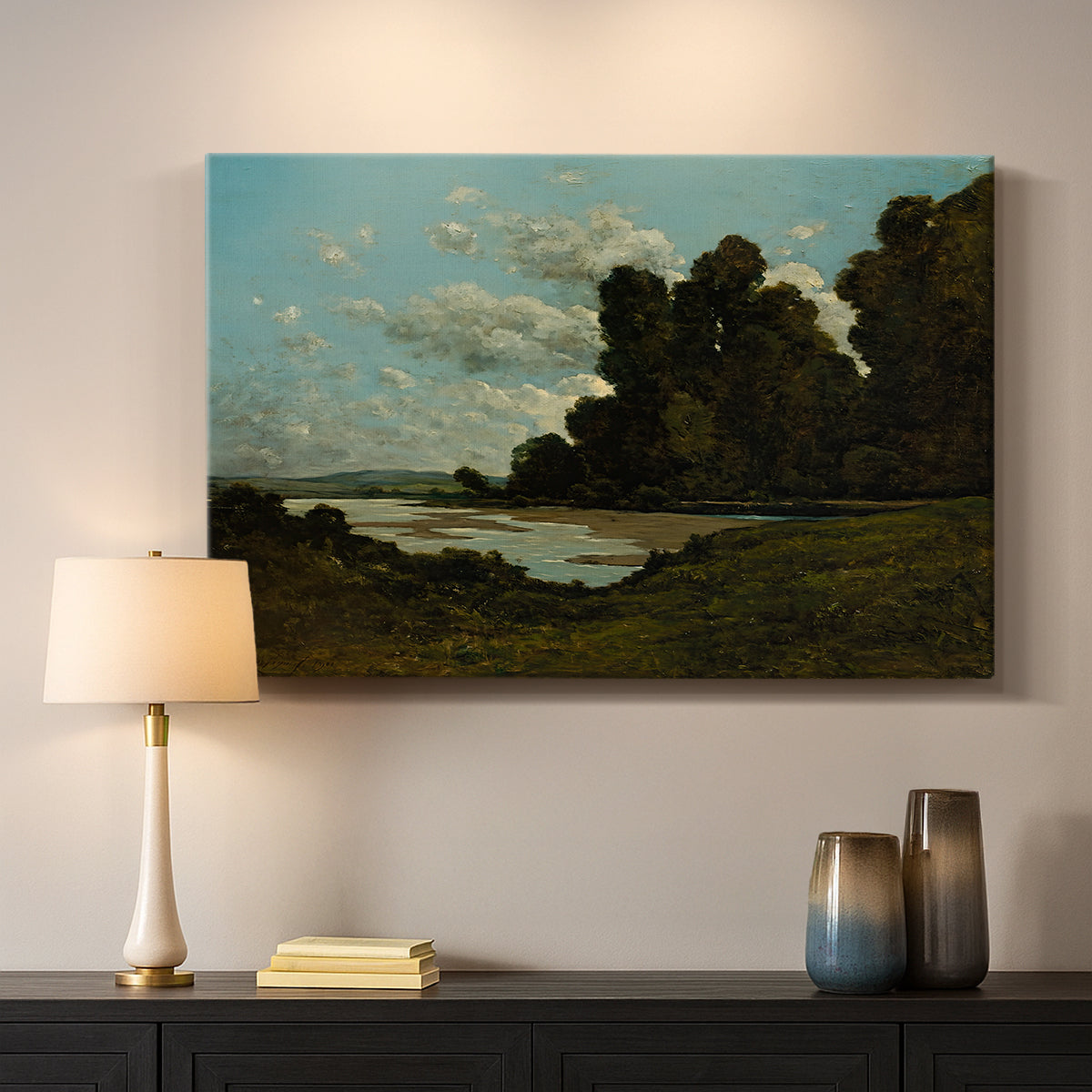Canvas art print detailing an expansive landscape with river and built environment, mounted in a softly lit interior space