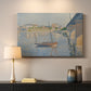 Canvas art print detailing a riverside composition with boats, mounted in a softly lit interior space