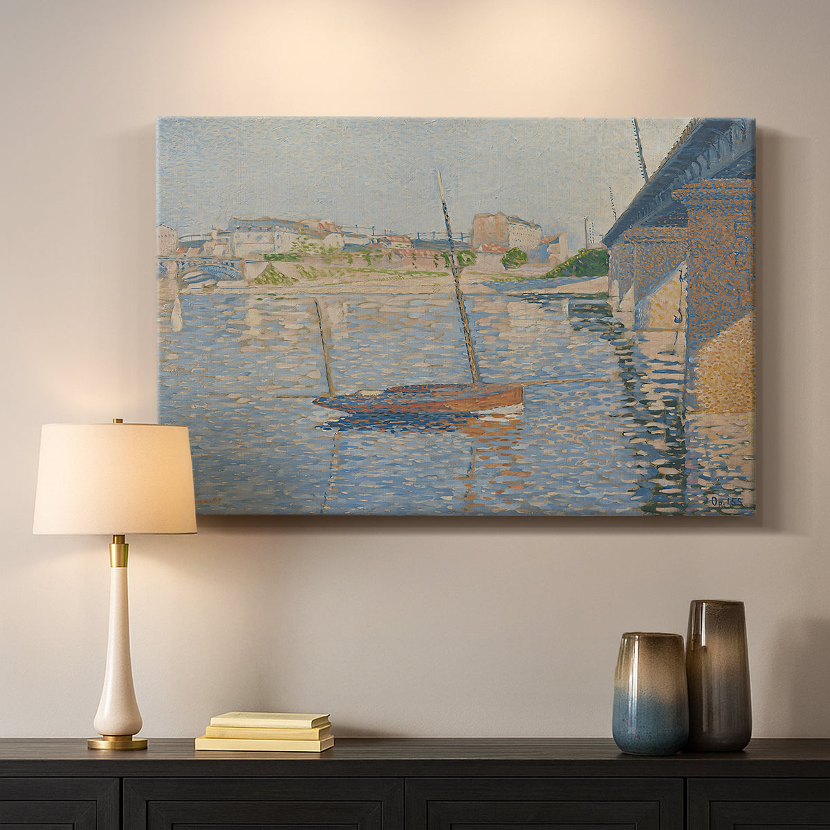 Canvas art print detailing a riverside composition with boats, mounted in a softly lit interior space