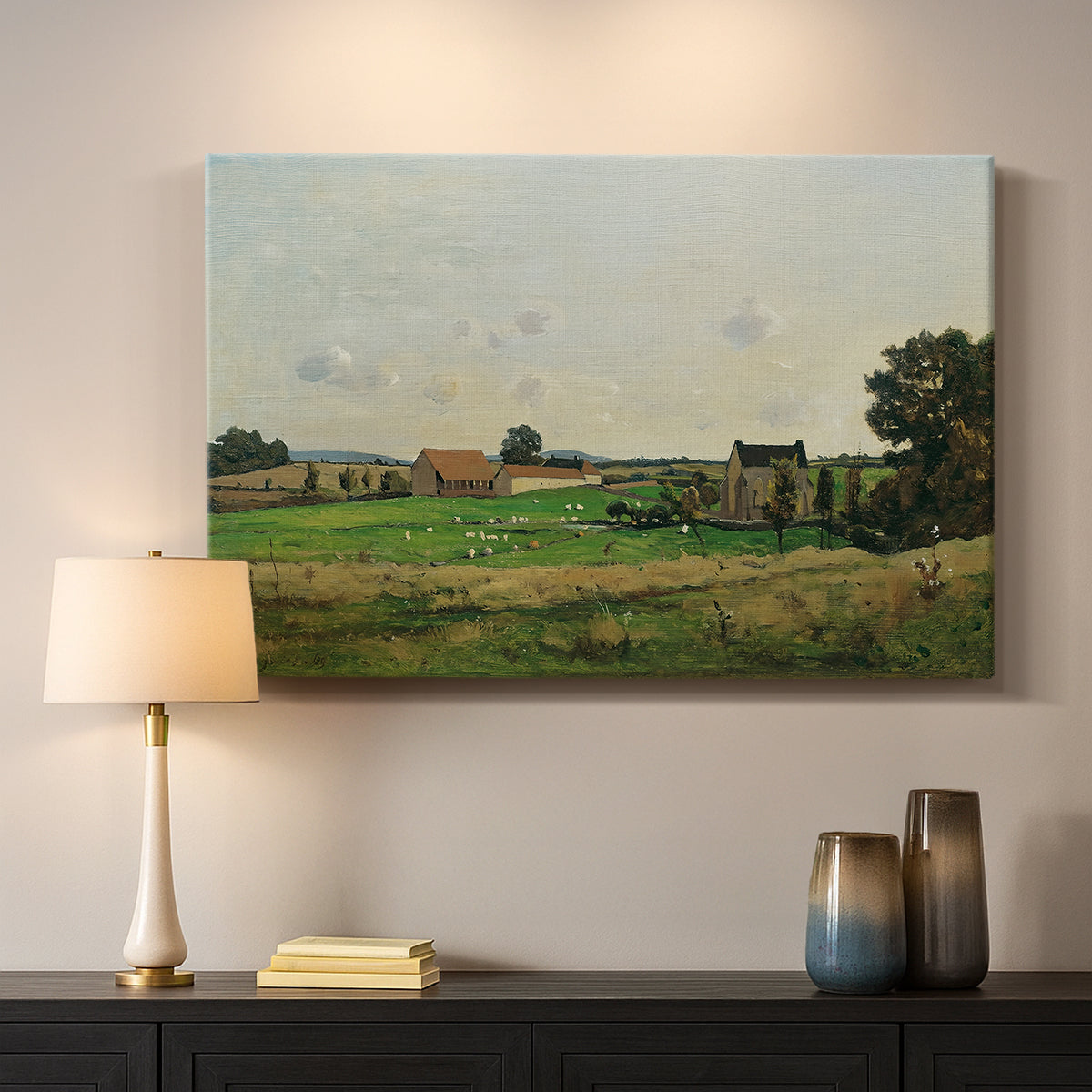 Canvas art print detailing a peaceful landscape with structure and open terrain, mounted in a softly lit interior space