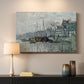 Canvas art print detailing a harbor view with masts, houses, and reflections in water, mounted in a softly lit interior space
