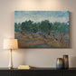 Canvas art print detailing a countryside composition with trees and dynamic color, mounted in a softly lit interior space