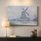 Canvas art print detailing a landscape combining structure and water, mounted in a softly lit interior space