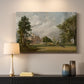 Canvas art print detailing a countryside view with house and vegetation, mounted in a softly lit interior space