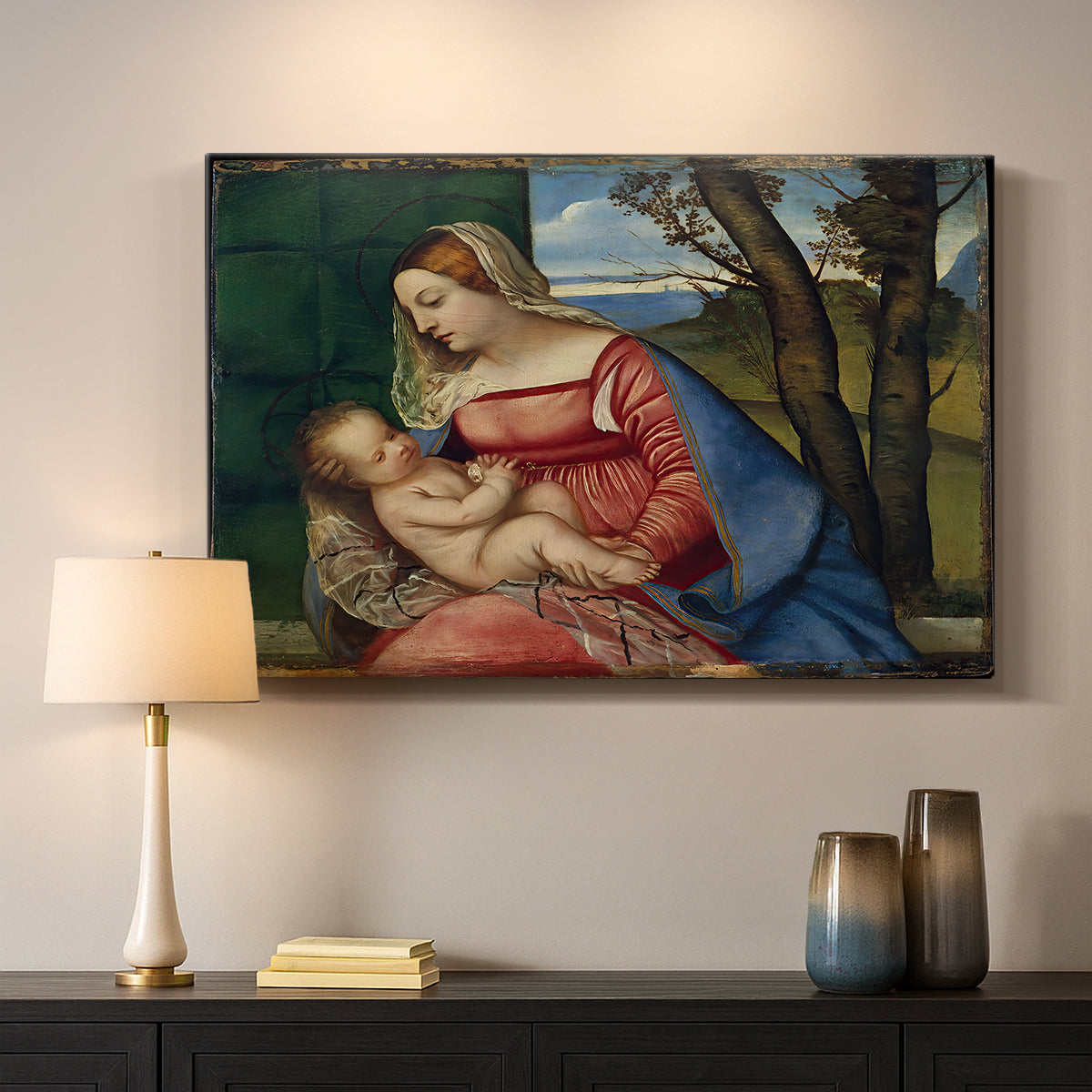 Canvas art print detailing a sacred figure study with child held against dark background, mounted in a softly lit interior space