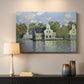 Canvas art print detailing a waterfront architecture with still reflections, mounted in a softly lit interior space