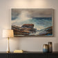 Canvas art print detailing a shoreline view with surf and coastal elements, mounted in a softly lit interior space