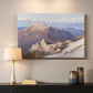Canvas art print detailing an expansive mountainous landscape with natural depth, mounted in a softly lit interior space